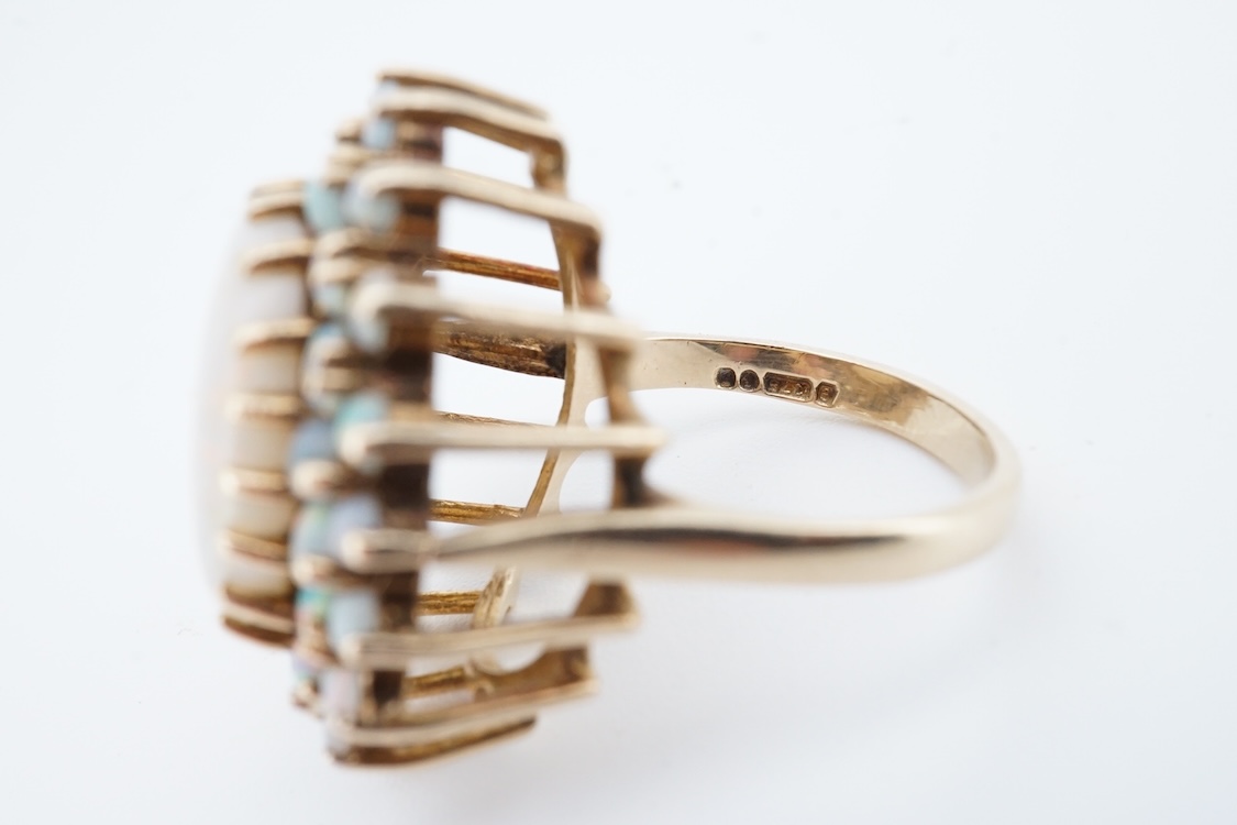 An early 1970's 9ct gold and opal cluster set dress ring, size O, gross weight 9 grams.
